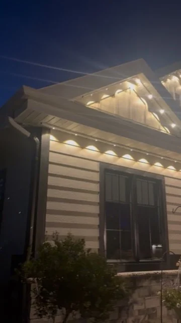 Real Kussmaul Co. permanent lighting installation glowing warm white along a gable at dusk