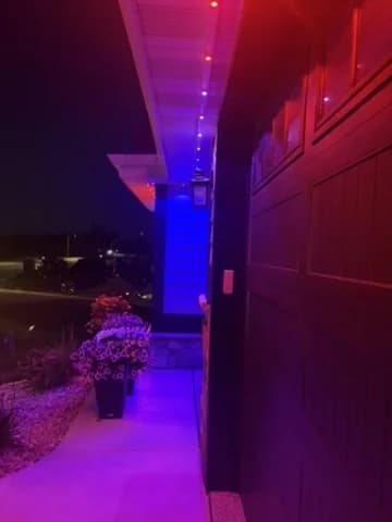Real Kussmaul Co. permanent lighting system lighting a porch in a color scene