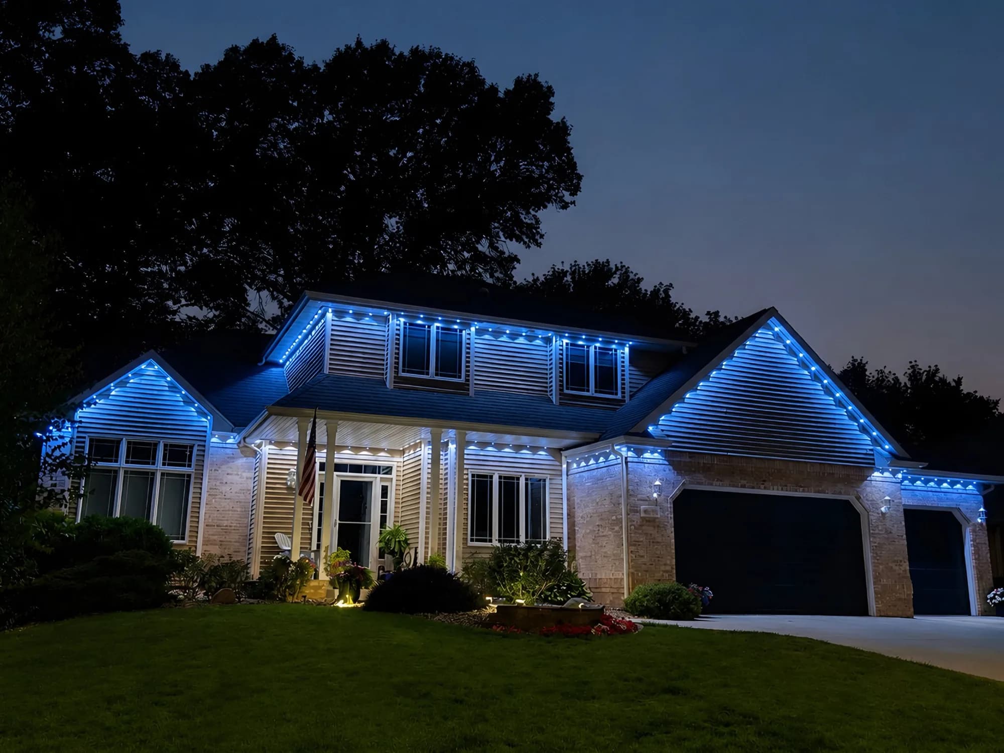 Real Kussmaul Co. permanent lighting in blue and white across a large two-story home