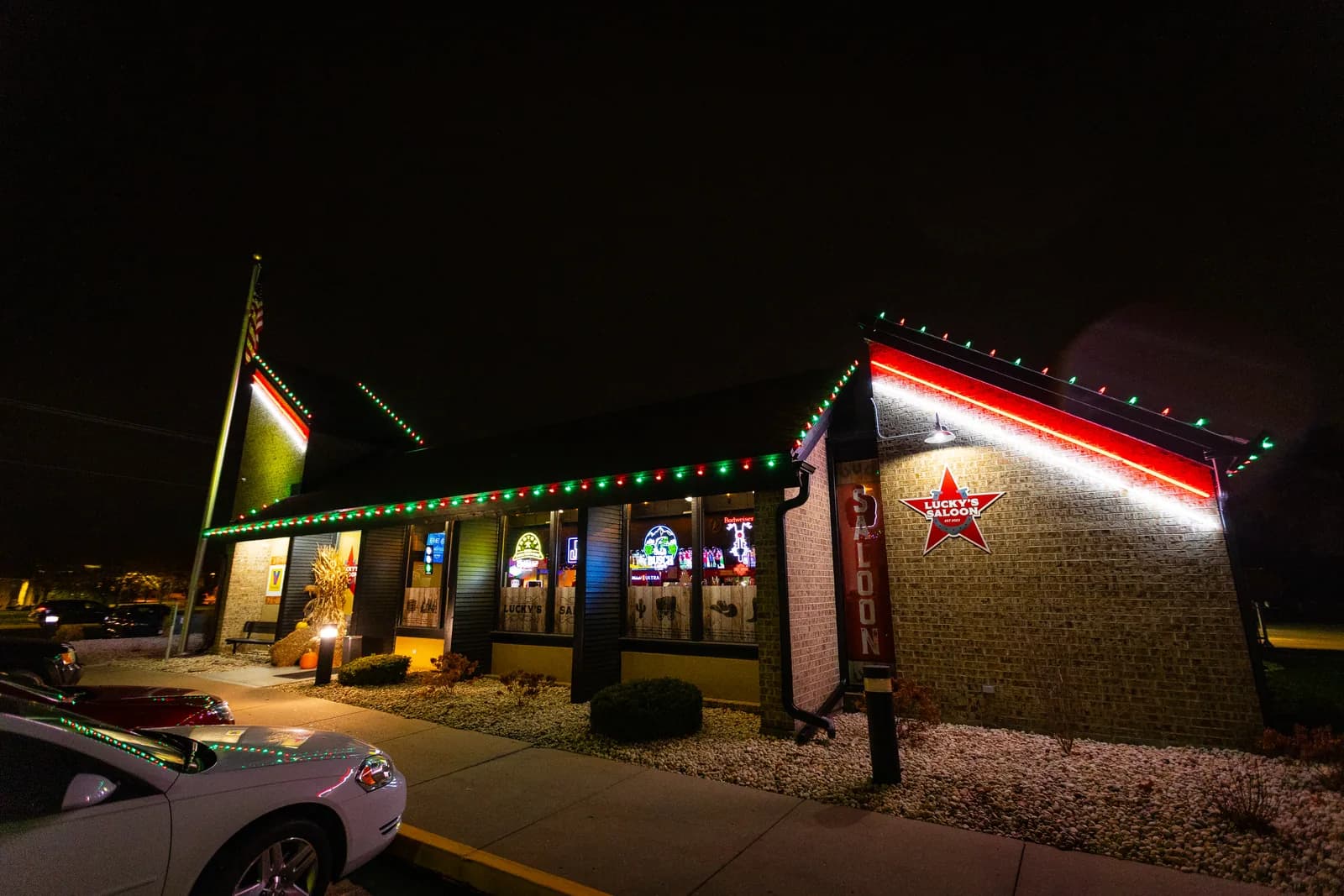 Real Kussmaul Co. holiday lighting installation on a commercial building's corner tower with red and green lights