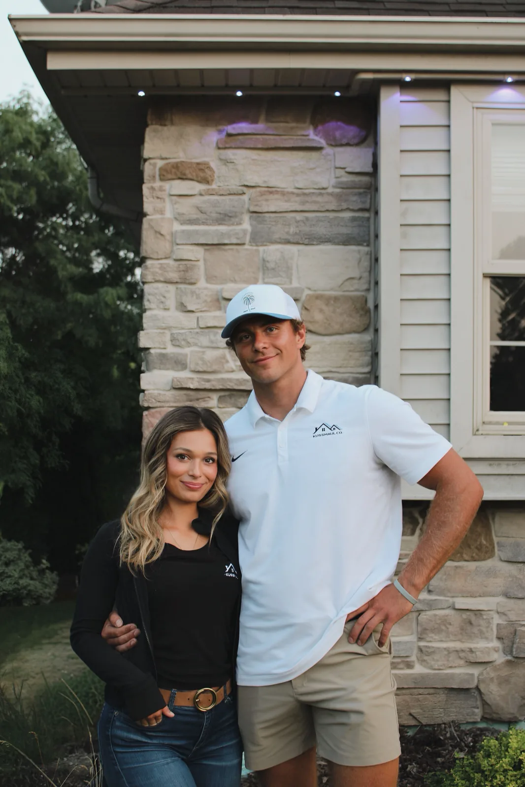 Tressin Kussmaul and his fiancée in Kussmaul Co. gear under a permanent lighting install