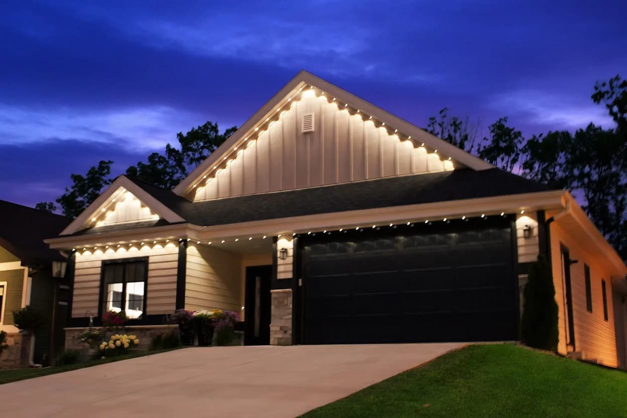 Real Kussmaul Co. permanent lighting in warm white under a deep purple dusk sky