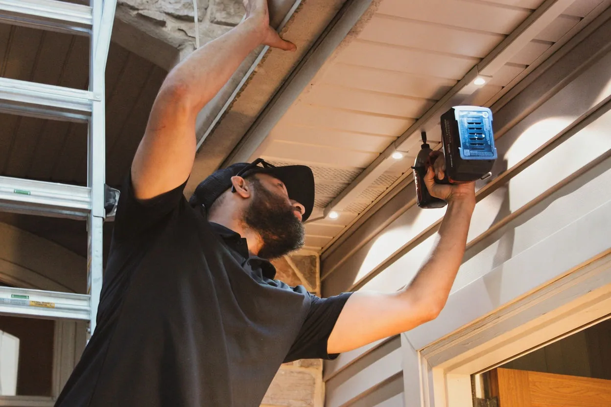Kussmaul Co. installer fastening lighting track under a soffit with engineered fasteners
