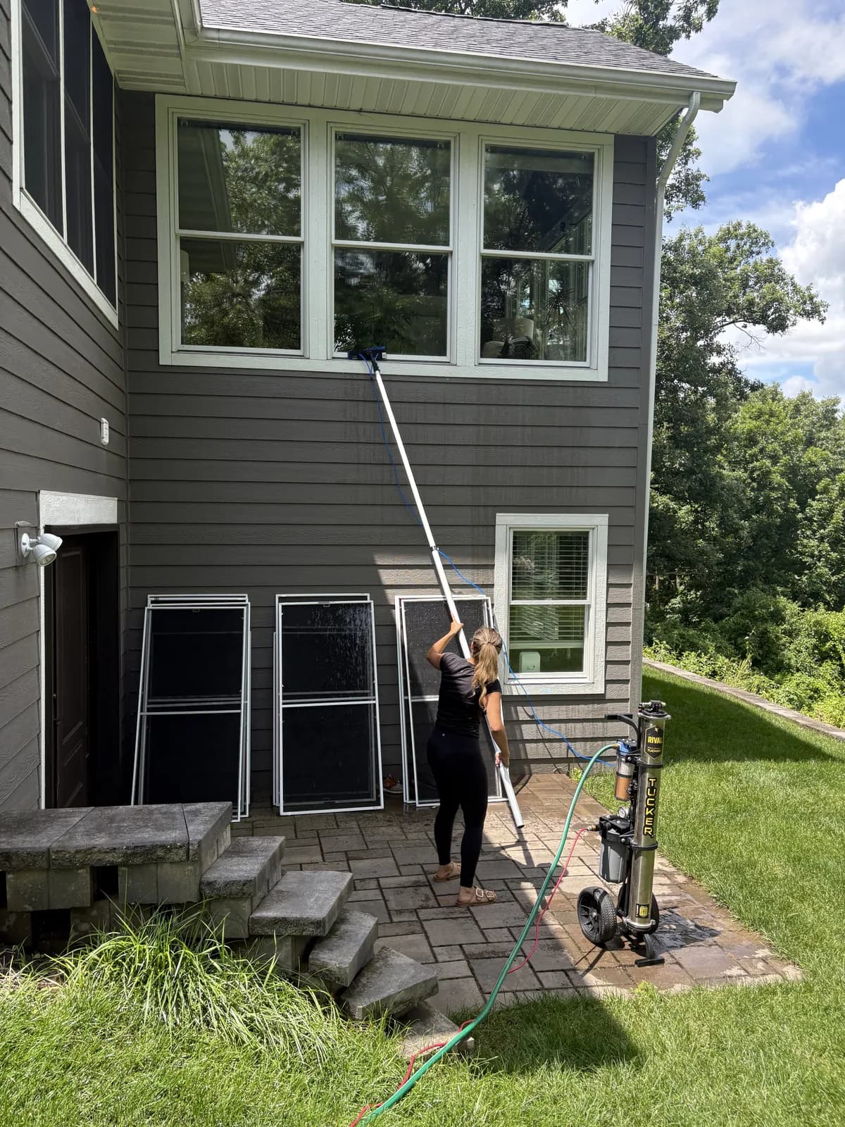 Real Kussmaul Co. technician cleaning second-story windows with a water-fed pure-water pole